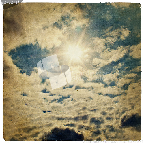 Image of Sun on blue sky, vintage background.