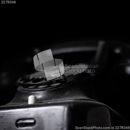 Image of Vintage dusted phone on dark background, with copyspace.