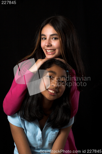 Image of teen posing over black backdrop