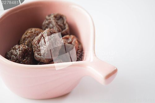 Image of Sweet dry pink plum in cup up close