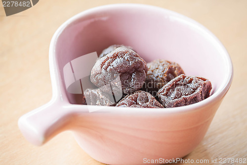 Image of Delicious dry pink plum in cup up close 