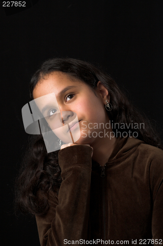 Image of teen posing over black backdrop