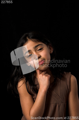 Image of teen posing over black backdrop