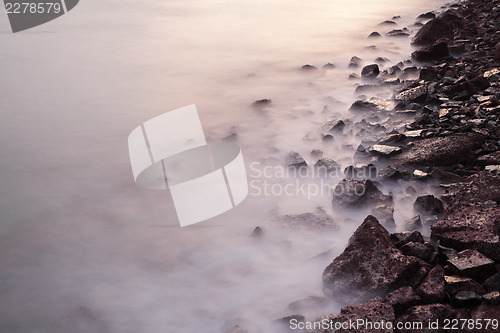Image of Sea coast wave and rock during sunset
