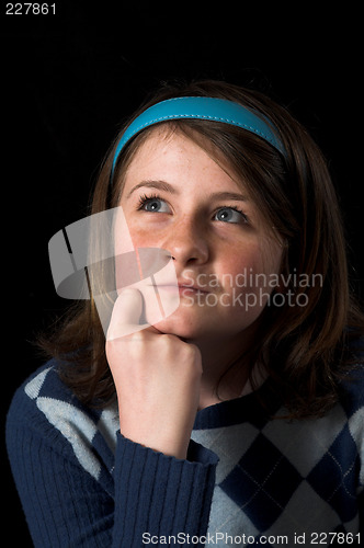 Image of teen posing over black backdrop