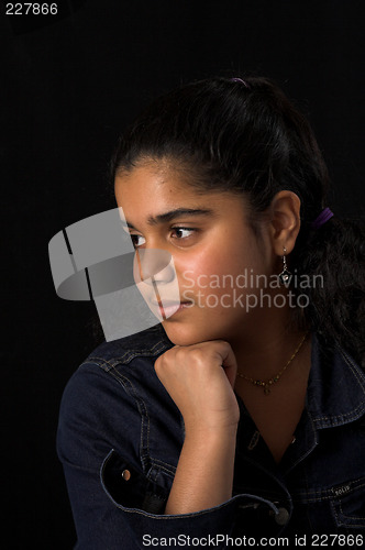 Image of teen posing over black backdrop