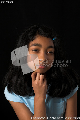 Image of teen posing over black backdrop