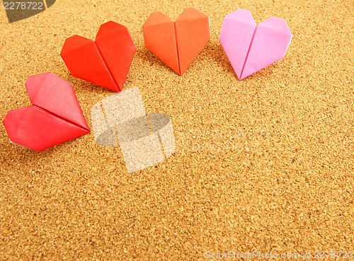 Image of Origami colorful heart on corkboard