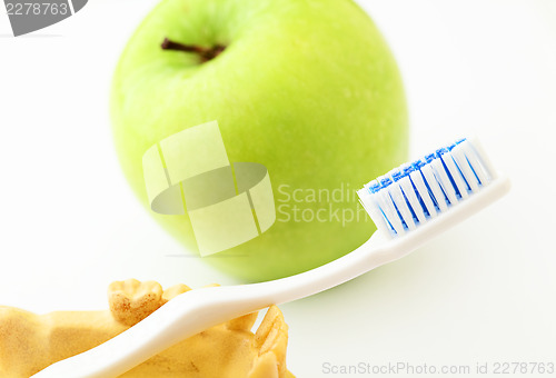 Image of Dental health care  concept, green apple and toothbrush