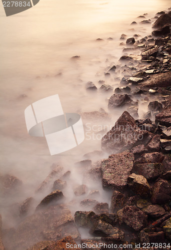 Image of Sea coast wave and rock at sunset