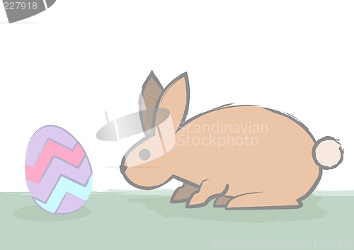 Image of easter bunny sniffs egg