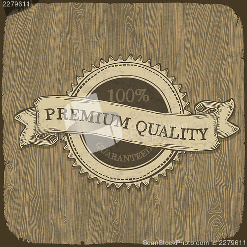 Image of Vintage label with premium quality text on wooden texture.  Vect