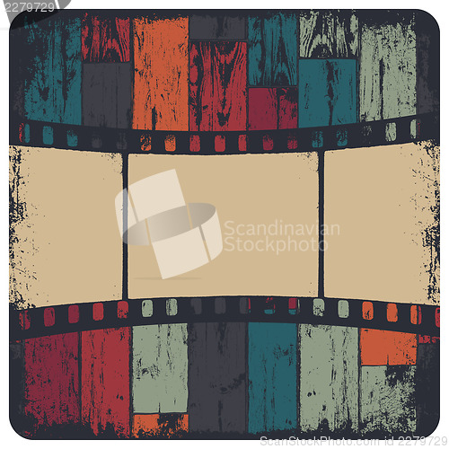 Image of Film strip in grunge frame on colorful seamless wooden backgroun