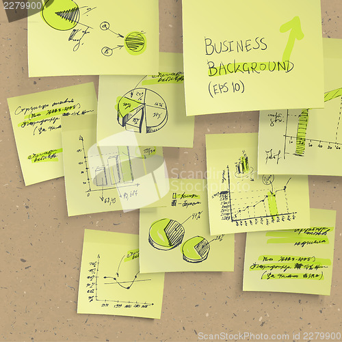 Image of Yellow sticky notes with business infographics on cork board, cl