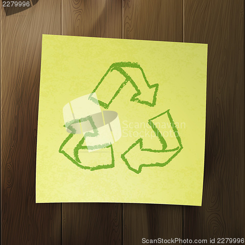 Image of Recycle symbol on wooden background.