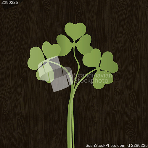 Image of Clover leaves on wooden weathered texture. Vector, EPS10.