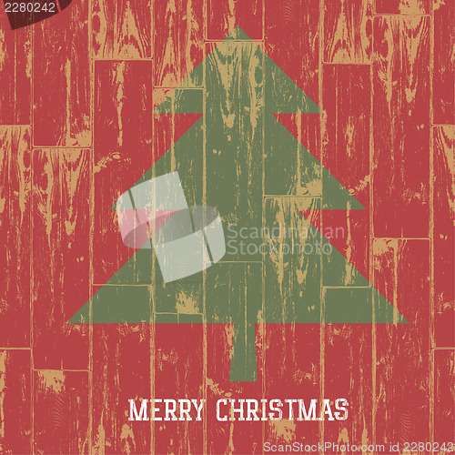 Image of Christmas tree symbol and greetings on wooden planks texture. Ve