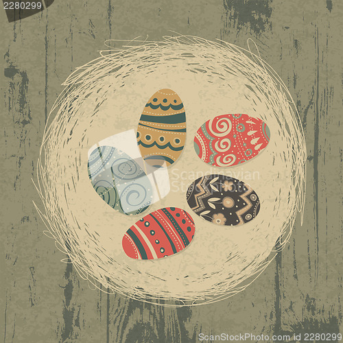 Image of Easter eggs in nest on wooden texture. Easter background, retro 