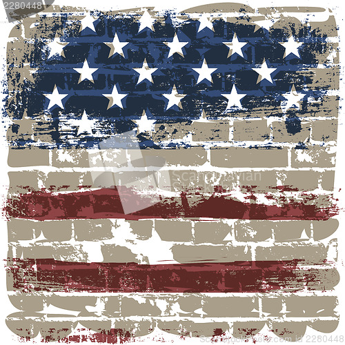 Image of The American flag against a brick wall.