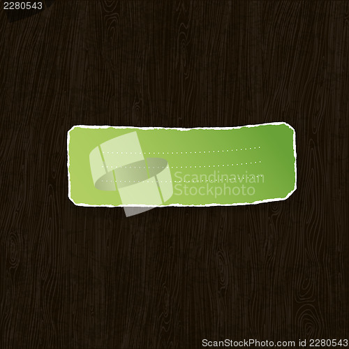 Image of Green torn label on wooden texture. Vector illustration, EPS10