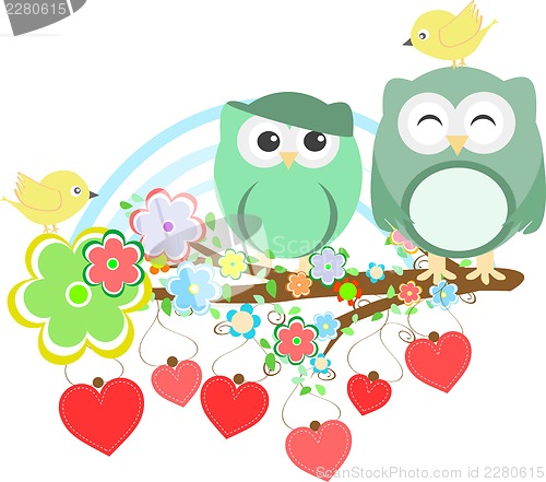 Image of Two cute owls and bird on the flower tree branch