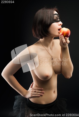 Image of Topless woman offers apple