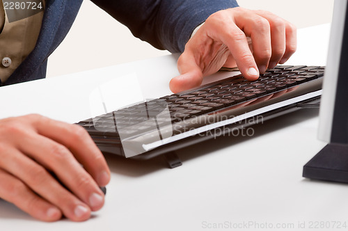 Image of Man Working at a Computer Keyboard