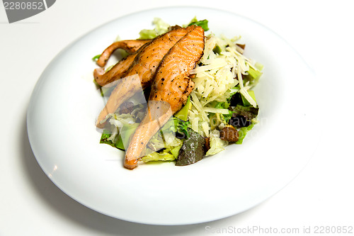 Image of Grilled salmon steak with herbs and vegetables