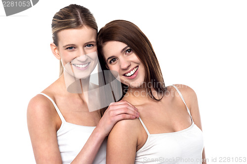 Image of Two attractive girls posing in sleeveless spaghetti