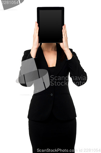 Image of Woman hiding her face with tablet pc
