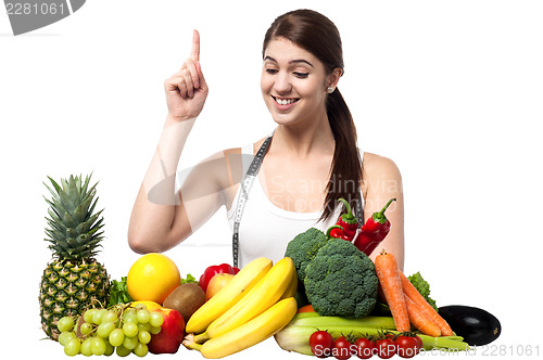 Image of Young smiling woman with fruits and vegetables