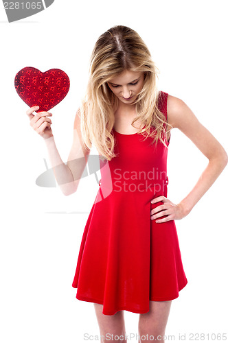 Image of Girl holding valentine gift looking down