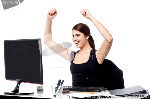 Image of Excited business woman raising her hands.