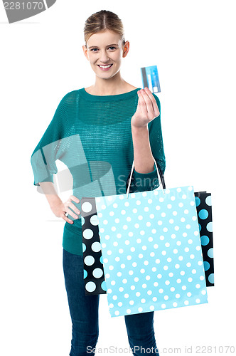 Image of Girl holding shopping bags and credit card