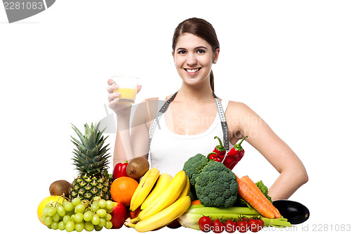 Image of Young woman with fruits and glass of juice