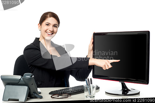 Image of Lady pointing something on computer screen