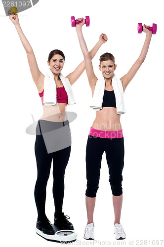 Image of Two smiling girls working out together