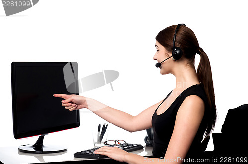 Image of Female executive pointing at computer screen