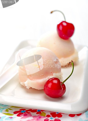 Image of fruit sorbet decorated with fresh red cherry