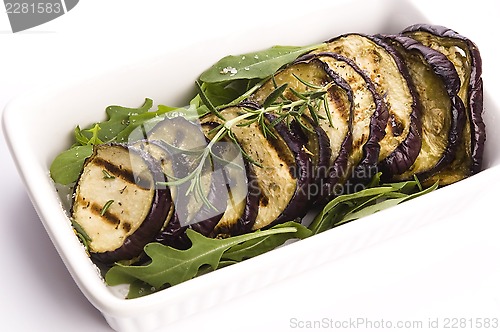 Image of Grilled eggplant slices on a plate with fresh rosemary