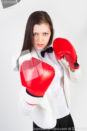 Image of young businesswoman in boxing gloves