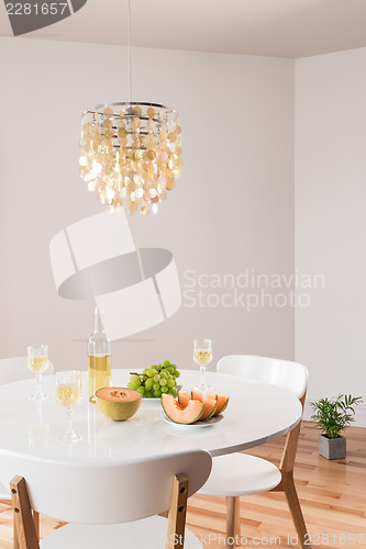 Image of Decorative chandelier and elegant table with white wine