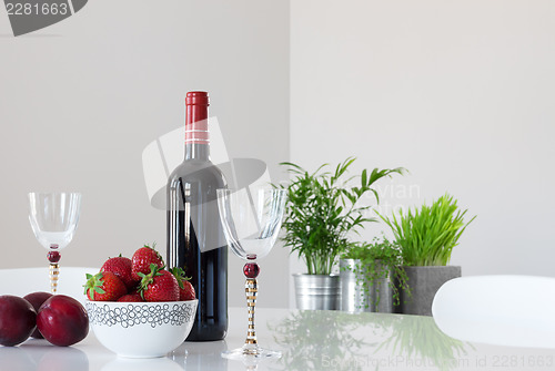 Image of Red wine, fruits and elegant glasses