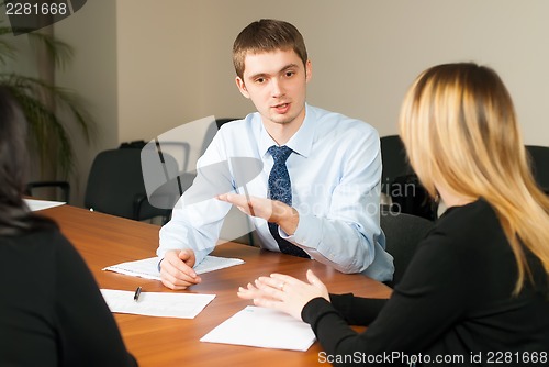 Image of Young and successful businessman in the office