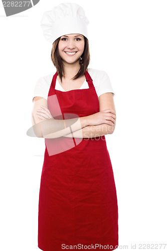 Image of Young female chef with folded arms