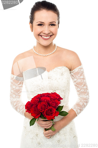 Image of Gorgeous pretty bride with a rose bouquet