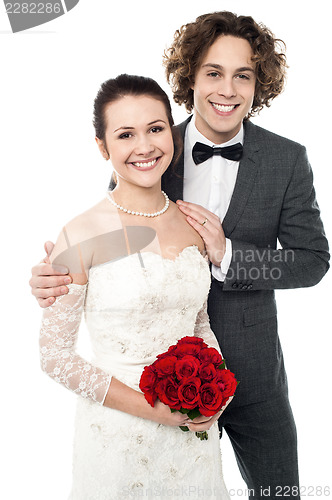 Image of Excited groom embracing beautiful bride