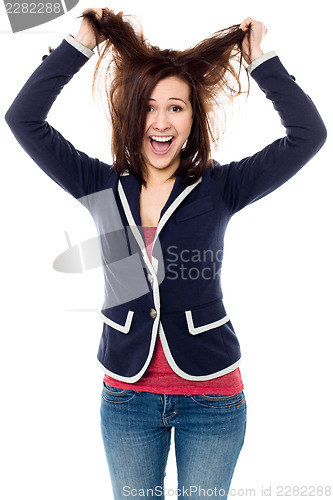 Image of Young girl pulling her hair in excitement