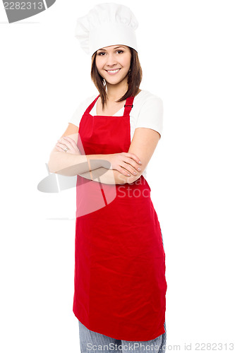 Image of Young baker woman with folded arms