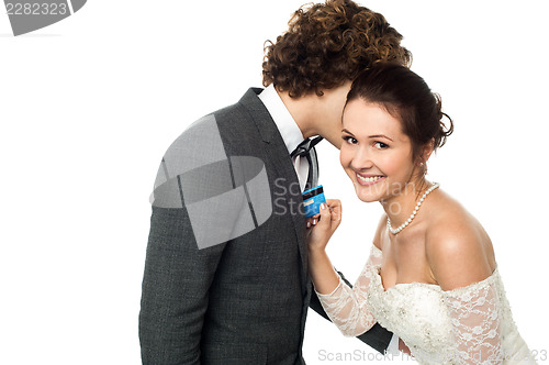 Image of Groom whispering sweet nothings